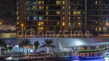 游艇和船只与游客停留在购物中心附近，并通<strong>过桥</strong>下迪拜码头区的夜晚